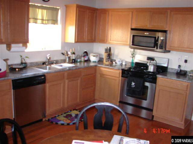 2904 Bryan Street Reno, NV 89503 - Photo 2 of 8 a kitchen with stainless steel appliances granite countertop a sink stove and microwave