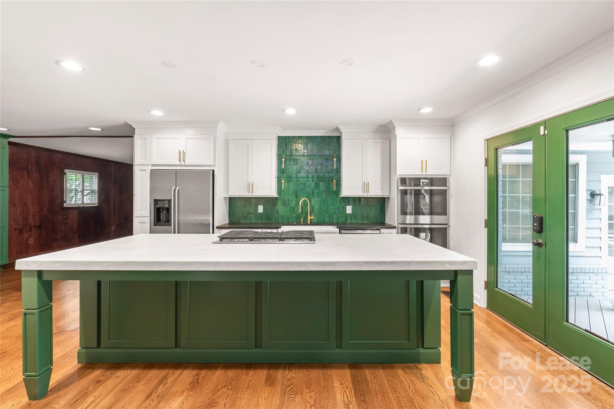 3726 Providence Road Charlotte, NC 28211 - Photo 11 of 45 a view of a kitchen with kitchen island a sink stainless steel appliances wooden floor and cabinets