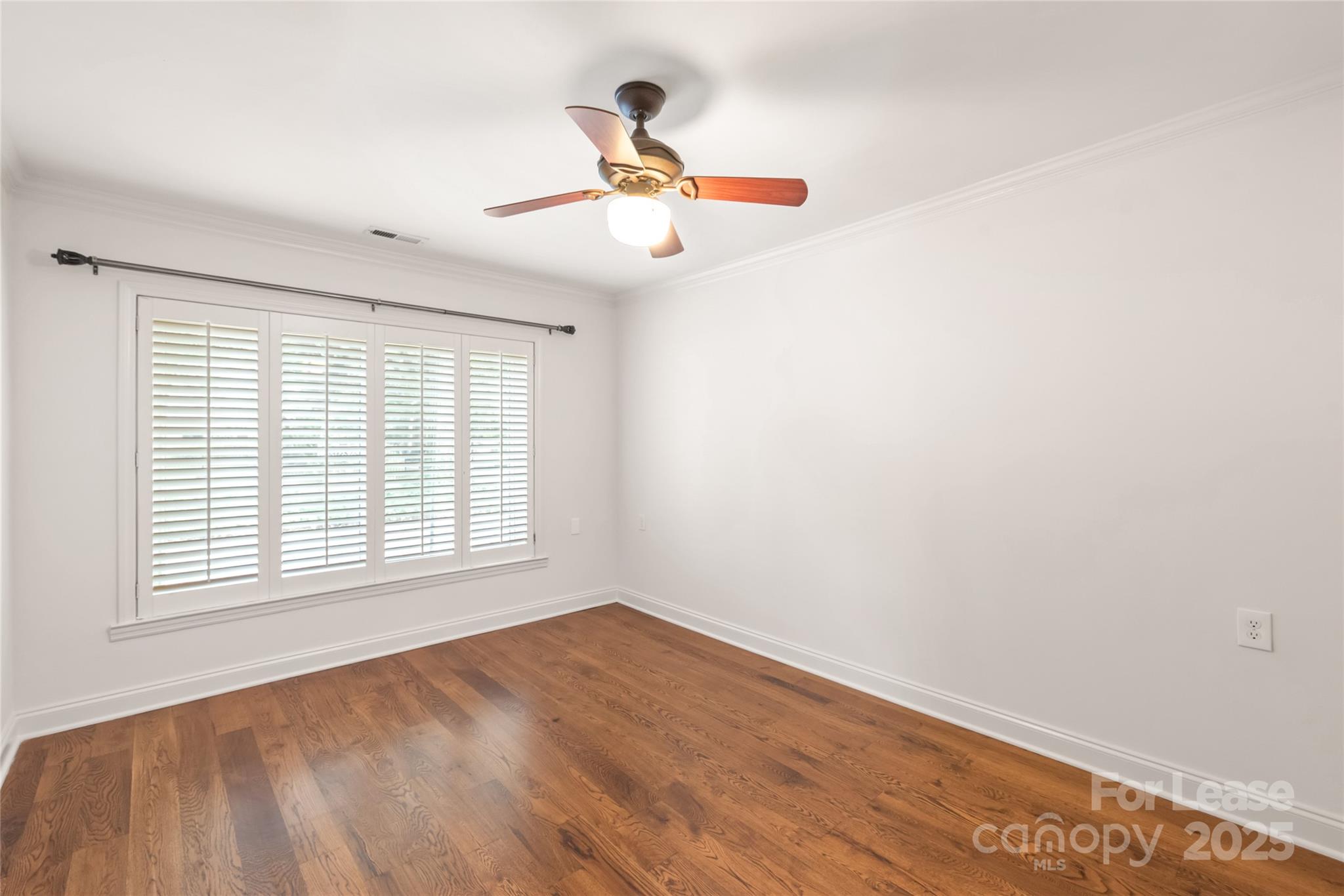 3726 Providence Road Charlotte, NC 28211 - Photo 20 of 45 an empty room with wooden floor fan and windows