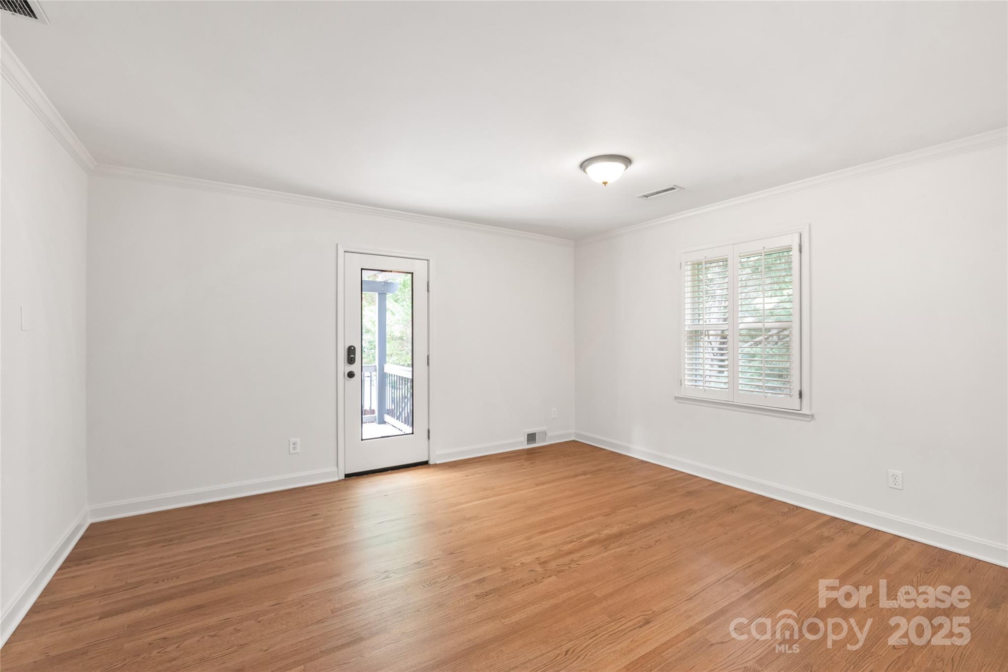 3726 Providence Road Charlotte, NC 28211 - Photo 23 of 45 a view of an empty room with wooden floor and a window