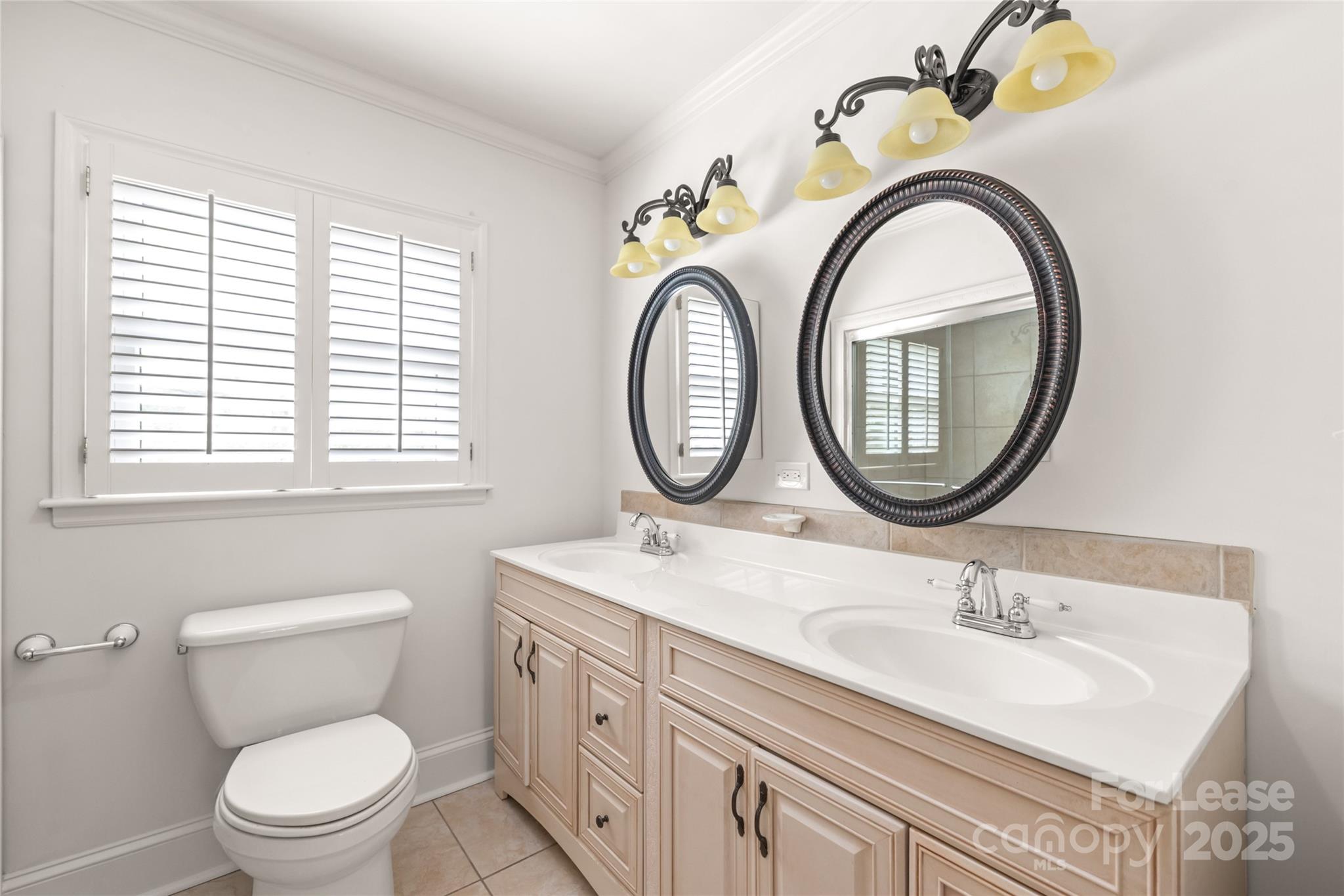 3726 Providence Road Charlotte, NC 28211 - Photo 27 of 45 a bathroom with a granite countertop toilet a sink and a mirror