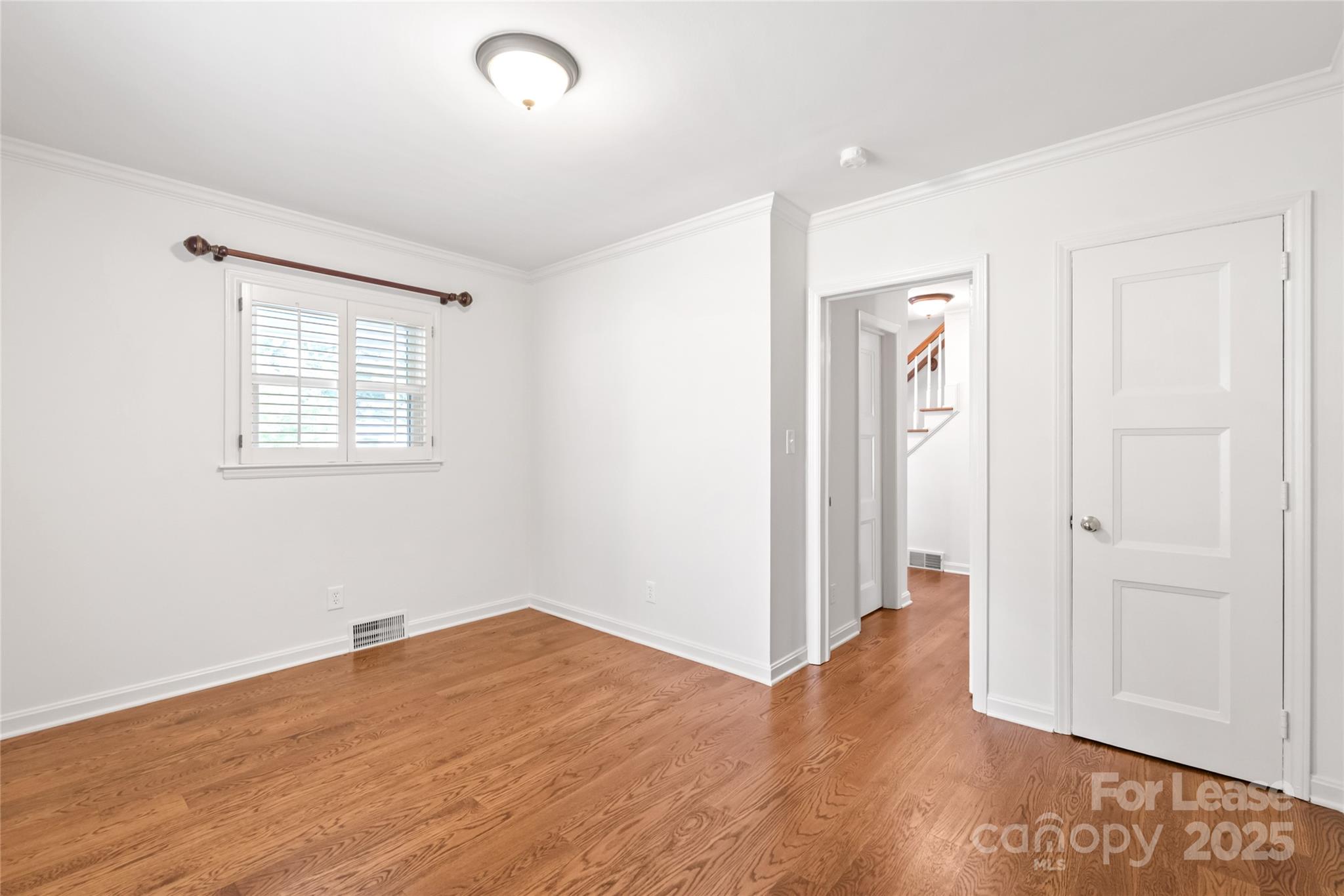 3726 Providence Road Charlotte, NC 28211 - Photo 6 of 45 an empty room with wooden floor and windows