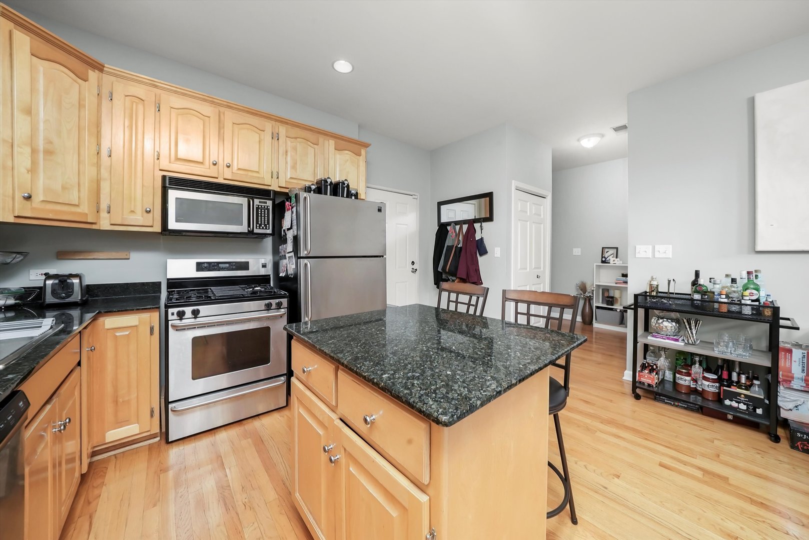 1535 West Ohio Street, Unit 2 Chicago, IL 60642 - Photo 11 of 25 a kitchen with stainless steel appliances granite countertop a sink stove and refrigerator