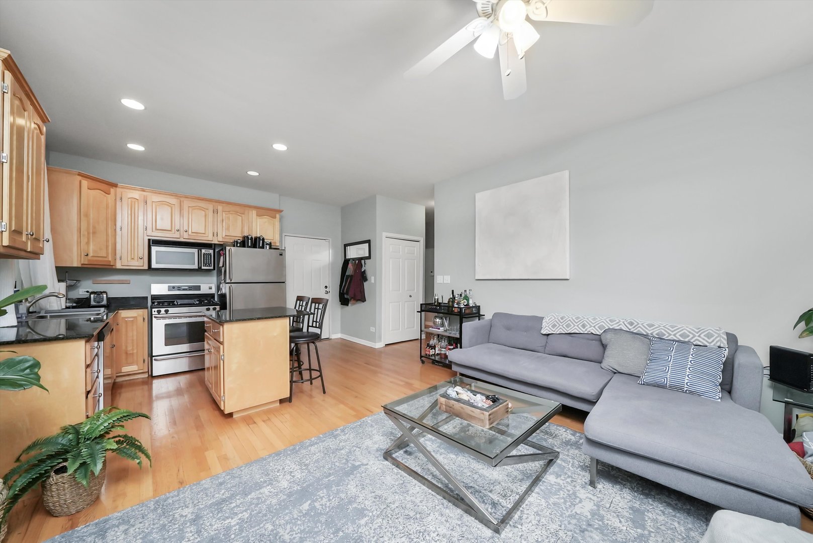 1535 West Ohio Street, Unit 2 Chicago, IL 60642 - Photo 13 of 25 a living room with furniture kitchen view and a chandelier