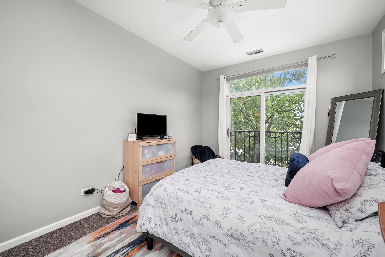 1535 West Ohio Street, Unit 2 Chicago, IL 60642 - Photo 16 of 25 a bedroom with a bed and a flat tv screen on the dresser