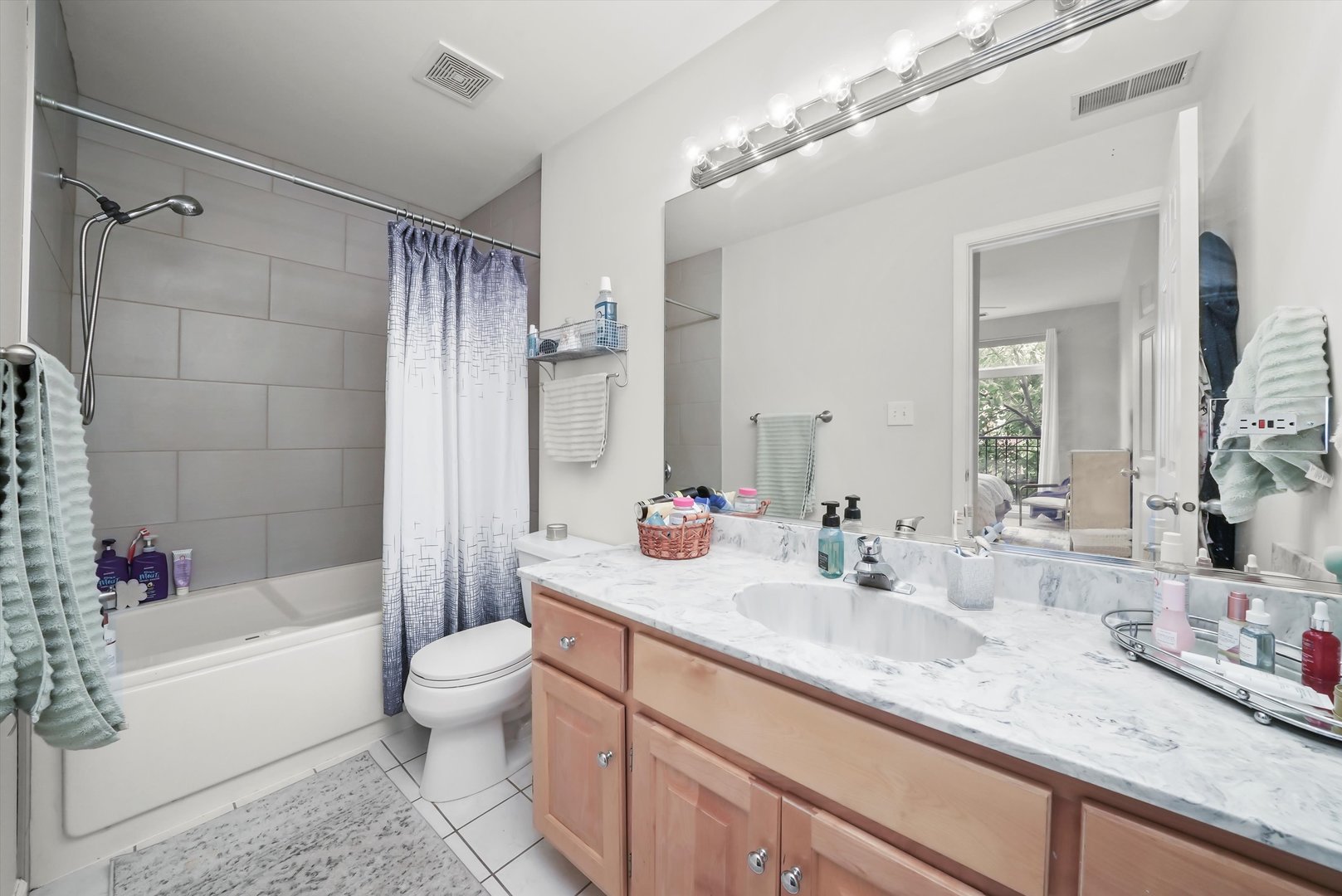 1535 West Ohio Street, Unit 2 Chicago, IL 60642 - Photo 22 of 25 a bathroom with a sink a toilet and shower