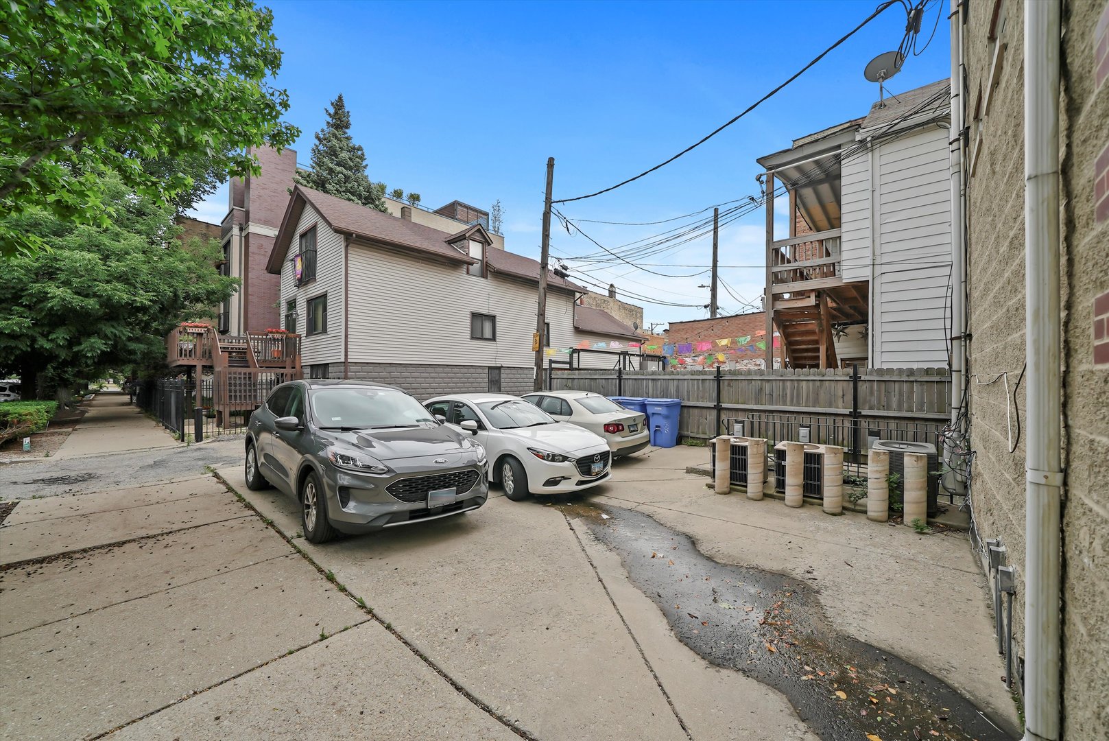 1535 West Ohio Street, Unit 2 Chicago, IL 60642 - Photo 23 of 25 a couple of cars parked in front of a house