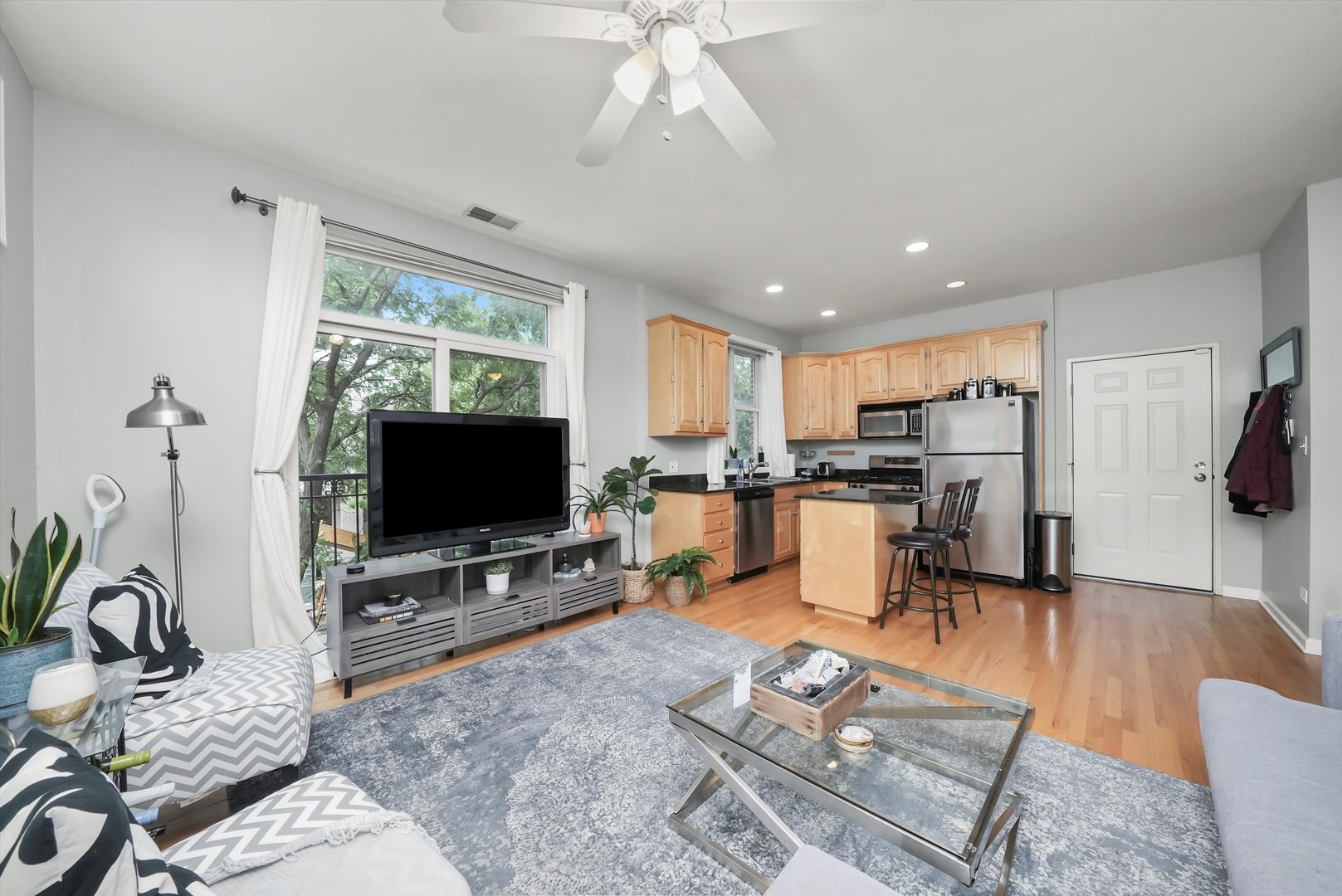 1535 West Ohio Street, Unit 2 Chicago, IL 60642 - Photo 10 of 25 a living room with furniture a flat screen tv and a table