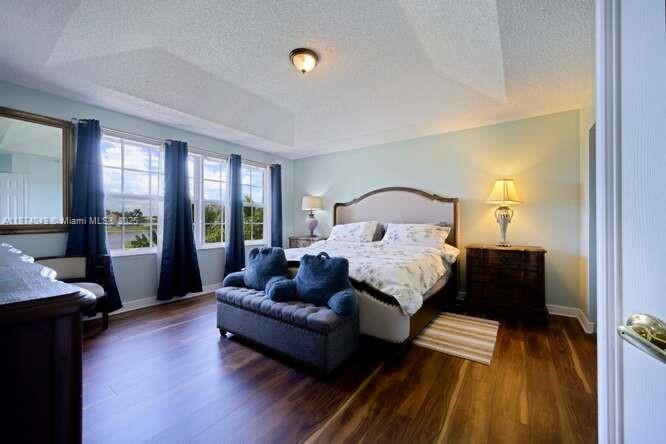 9770 Scribner Lane Wellington, FL 33414 - Photo 14 of 43 a bedroom with a bed wooden floor and window