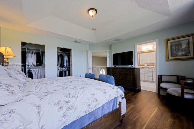 9770 Scribner Lane Wellington, FL 33414 - Photo 15 of 43 a bedroom with a bed and a flat screen tv