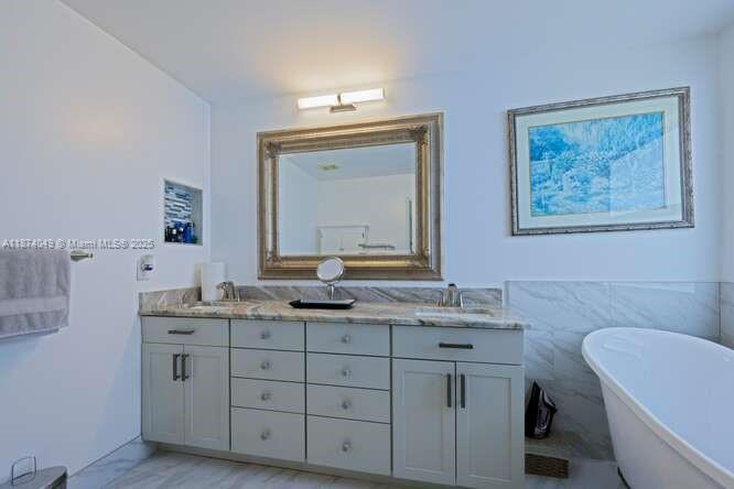 9770 Scribner Lane Wellington, FL 33414 - Photo 16 of 43 a bathroom with a granite countertop toilet a sink and a mirror