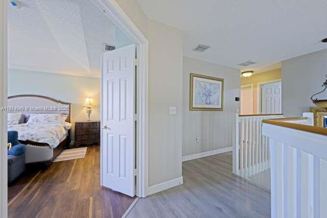 9770 Scribner Lane Wellington, FL 33414 - Photo 18 of 43 a bedroom with a bed and wooden floor