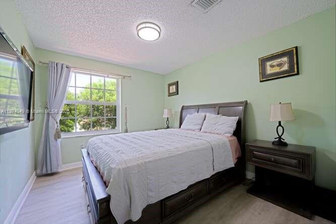 9770 Scribner Lane Wellington, FL 33414 - Photo 19 of 43 a bedroom with a bed and a window