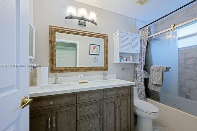 9770 Scribner Lane Wellington, FL 33414 - Photo 20 of 43 a bathroom with a sink a toilet and a mirror