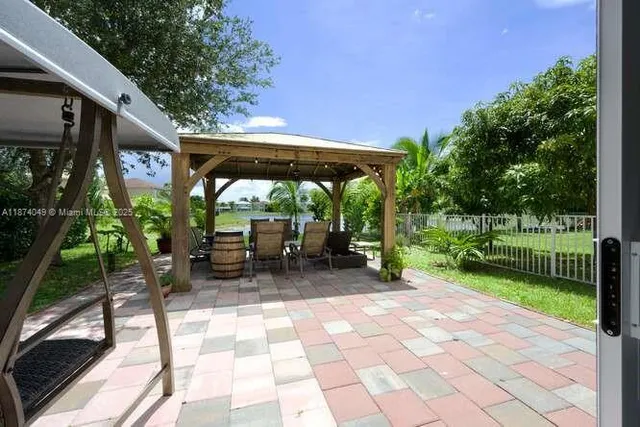 a view of backyard with patio