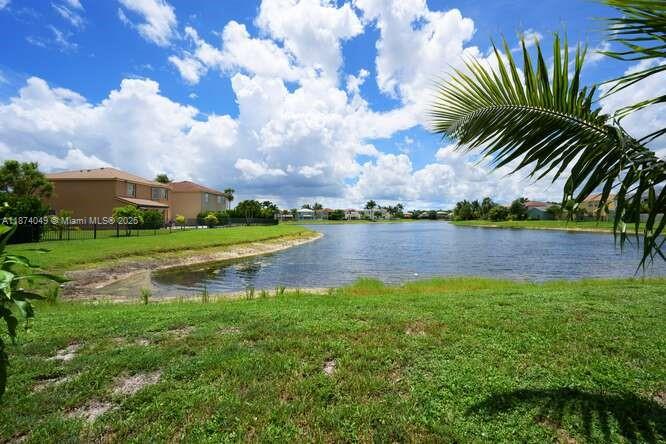 9770 Scribner Lane Wellington, FL 33414 - Photo 25 of 43 a view of a lake with a big yard and palm trees