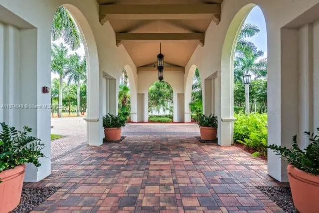 a view of a porch with furniture and a potted plant