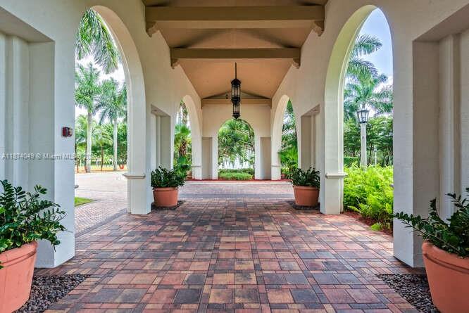 9770 Scribner Lane Wellington, FL 33414 - Photo 30 of 43 a view of a porch with furniture and a potted plant