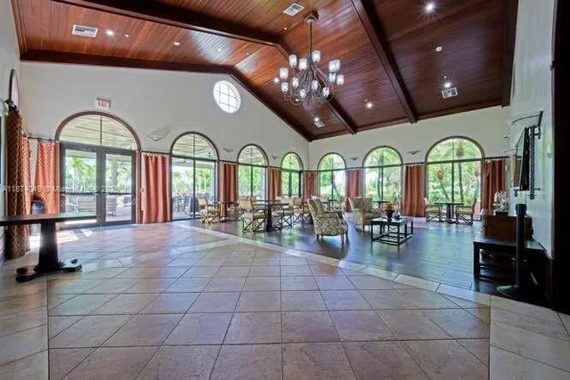 a media room with lots of chairs and wooden floor
