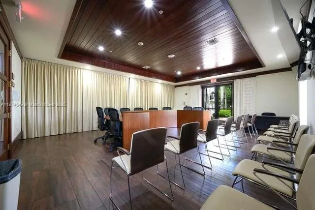 a view of living room filled with furniture and chandelier