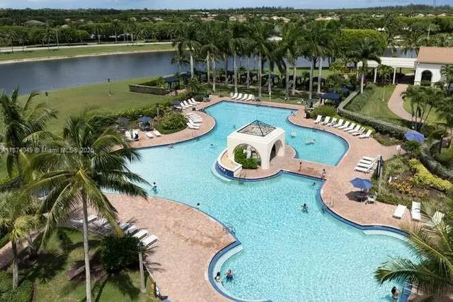 an aerial view of a house with a swimming pool outdoor seating