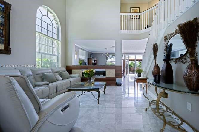 9770 Scribner Lane Wellington, FL 33414 - Photo 5 of 43 a living room with furniture a fireplace and a window