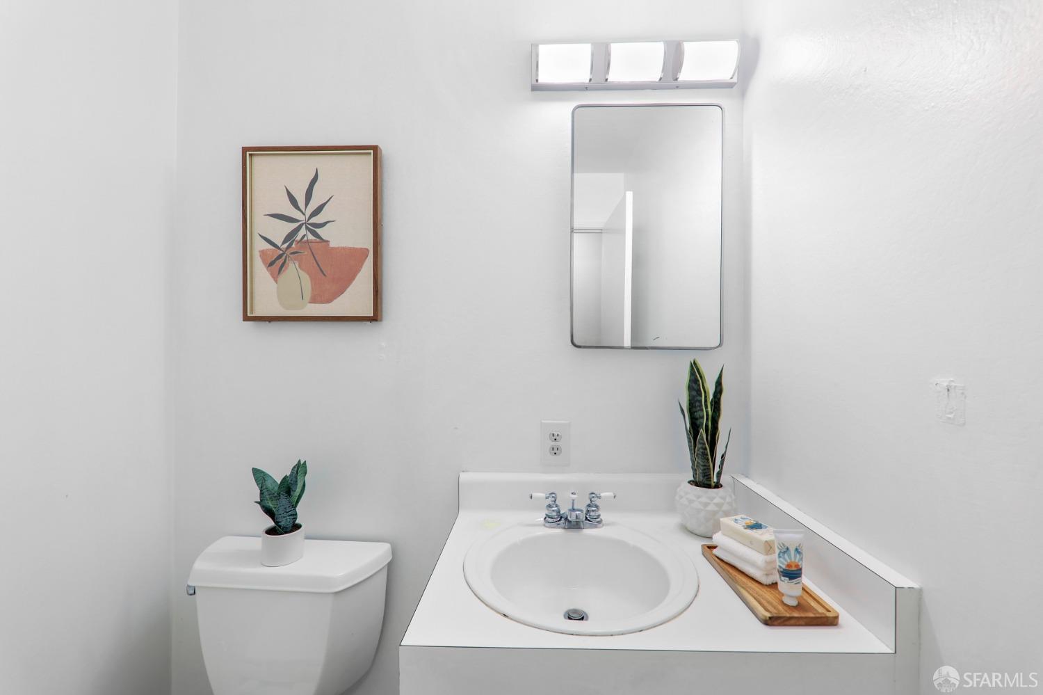20 Point Reyes Way Pacifica, CA 94044 - Photo 22 of 78 a bathroom with a toilet a sink and mirror