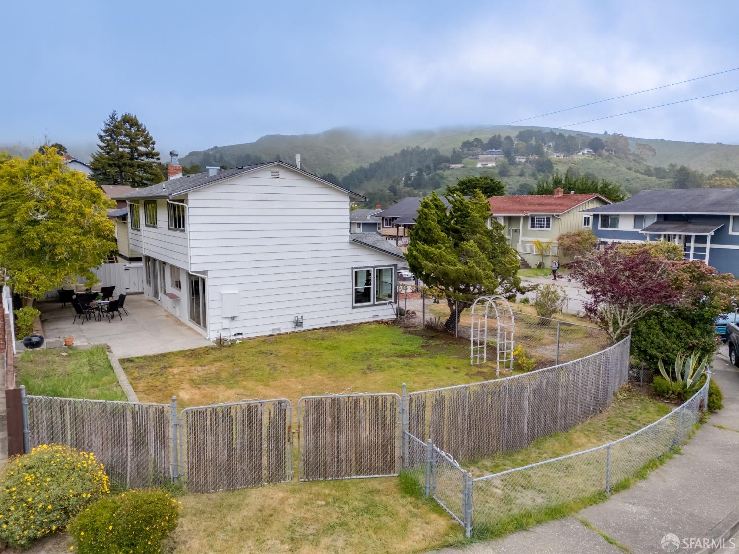 20 Point Reyes Way Pacifica, CA 94044 - Photo 73 of 78 a view of a house with a chairs in a patio