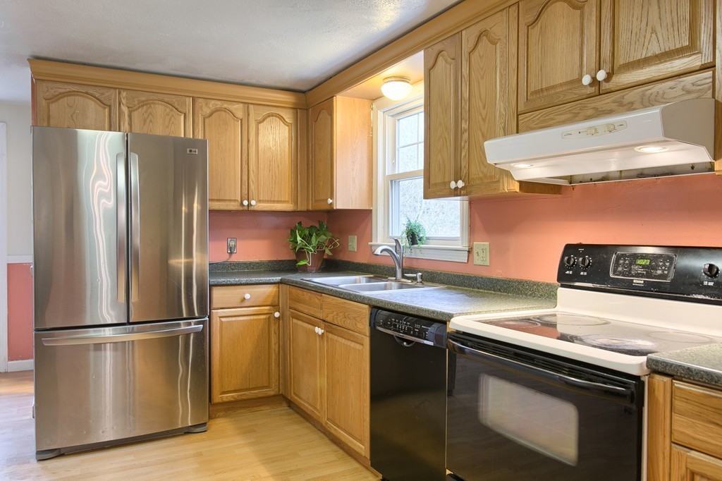 116 Crooked Spring Road Chelmsford, MA 01863 - Photo 8 of 24 a kitchen with a sink a refrigerator and window