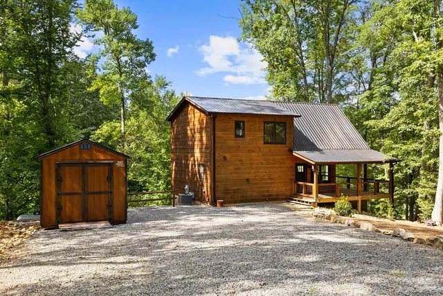 a backyard of a house with table and chairs