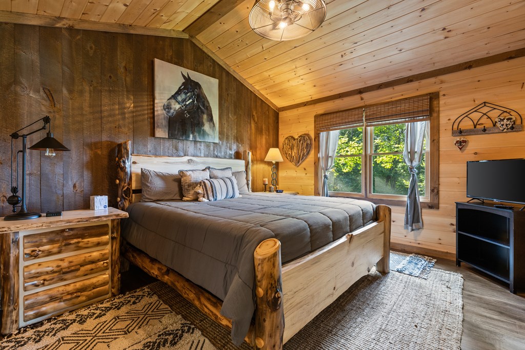 89 Whispering Hawk Trail Morganton, GA 30560 - Photo 12 of 33 a large bed sitting in a bedroom next to a window