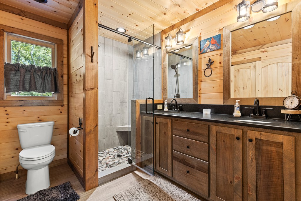 89 Whispering Hawk Trail Morganton, GA 30560 - Photo 13 of 33 a bathroom with a granite countertop sink toilet and shower