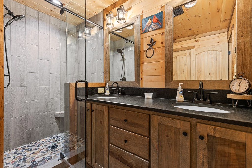 89 Whispering Hawk Trail Morganton, GA 30560 - Photo 14 of 33 a bathroom with a double vanity sink and a mirror