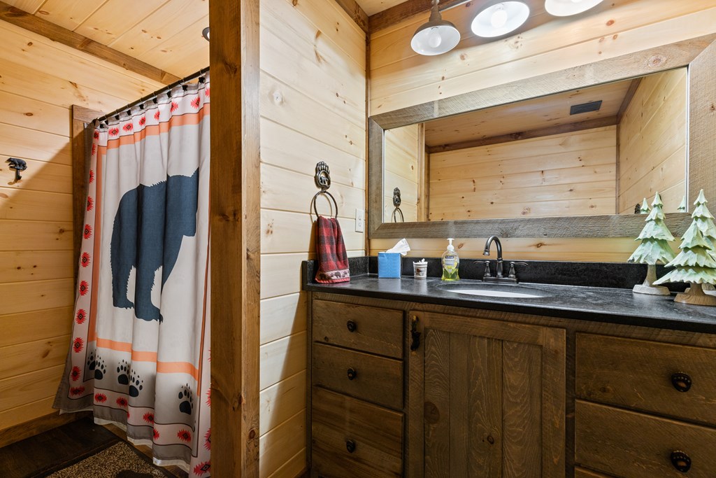 89 Whispering Hawk Trail Morganton, GA 30560 - Photo 22 of 33 a bathroom with a double vanity sink and a mirror