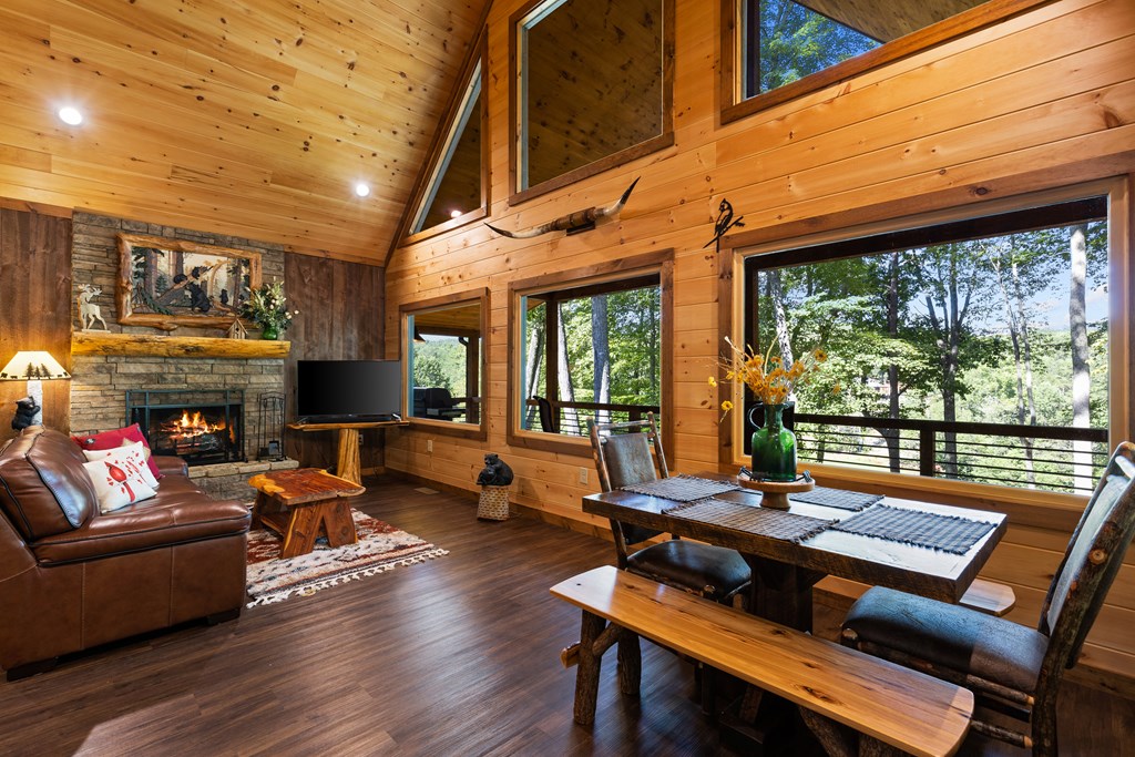 89 Whispering Hawk Trail Morganton, GA 30560 - Photo 6 of 33 a living room with furniture a fireplace and floor to ceiling window