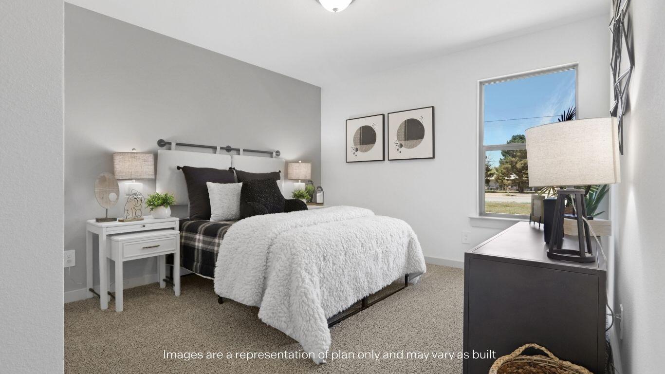7815 94th Street Lubbock, TX 79424 - Photo 13 of 15 a bedroom with a bed and a lamp on dresser