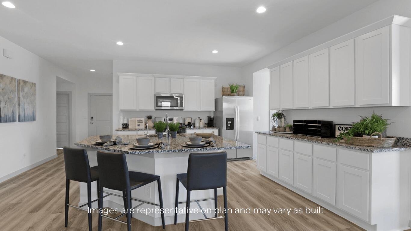 7815 94th Street Lubbock, TX 79424 - Photo 3 of 15 a kitchen with a dining table chairs and white cabinets