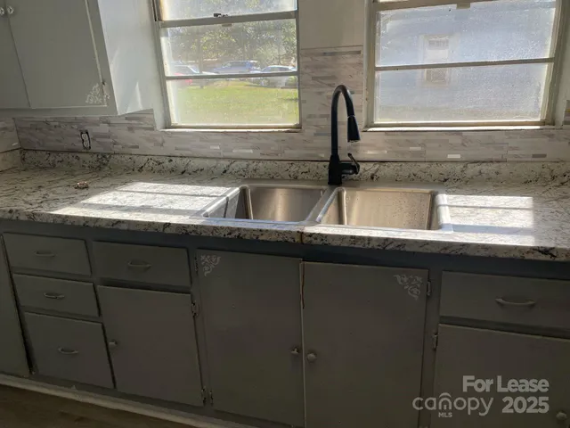 a kitchen with a sink and a window