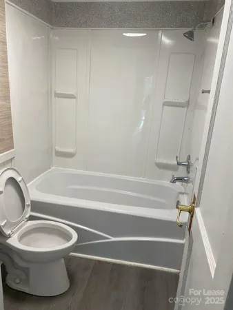 a bathroom with a toilet and a bathtub