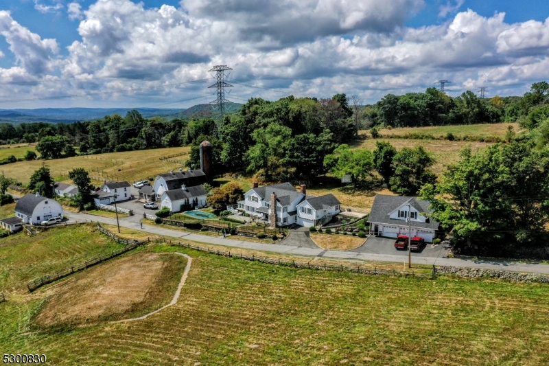 23 Charlottesburg Road Boonton, NJ 07005 - Photo 15 of 26 a view of a swimming pool with a table and chairs