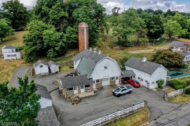 an aerial view of a house with garden space and lake view
