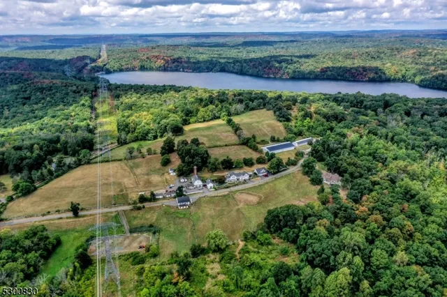 an aerial view of a house with a yard and lake view
