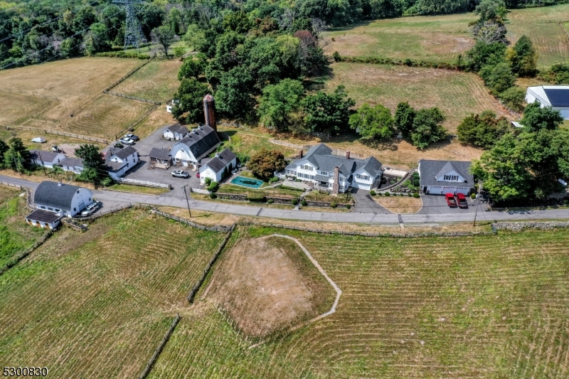 23 Charlottesburg Road Boonton, NJ 07005 - Photo 9 of 26 an aerial view of a house with swimming pool and lake view