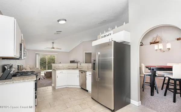 a kitchen with a refrigerator and a sink