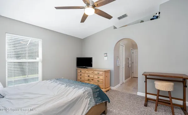 a bedroom with a bed and a tv