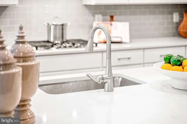 a kitchen with sink cabinets and stainless steel appliances