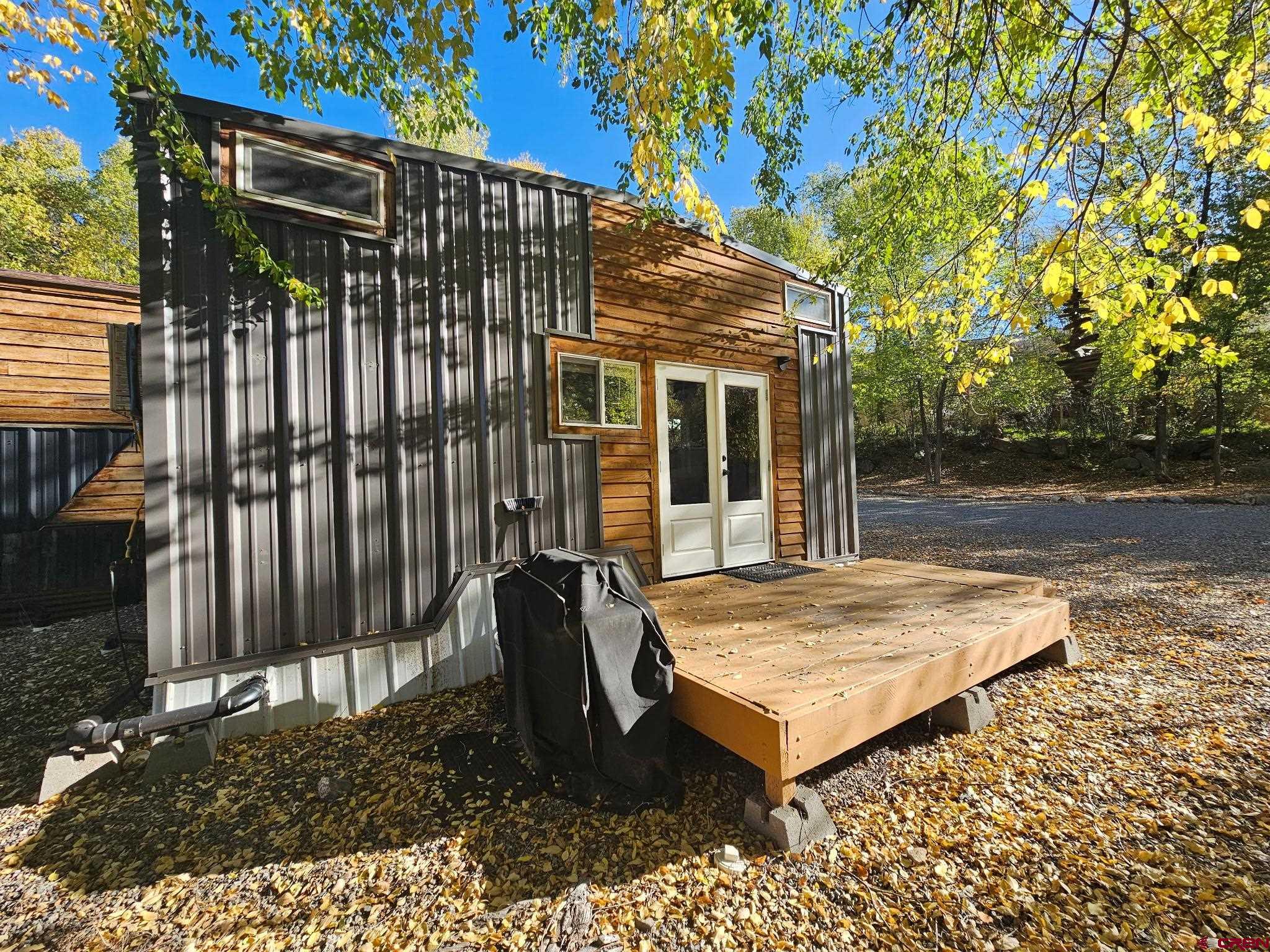 a view of backyard with barbeque grill and wooden fence