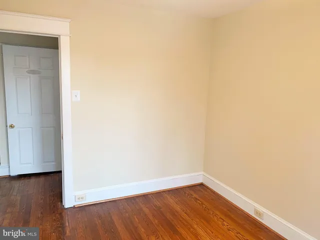 a view of a small space with wooden floor and a window
