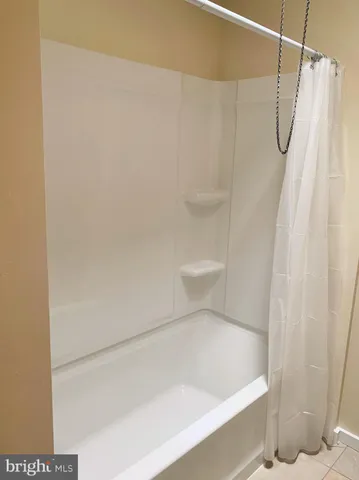 a bathroom with a shower curtain and toilet