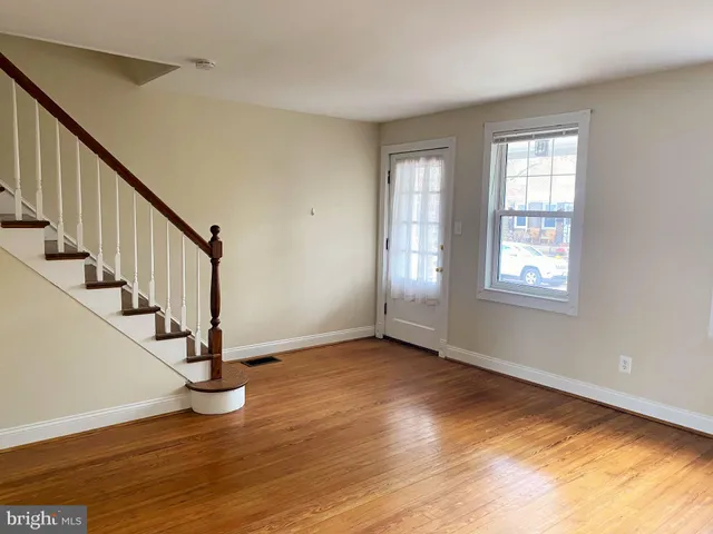 a view of an entryway with wooden floor and door